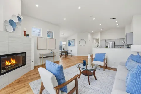 a view of a dining room with furniture and a fireplace