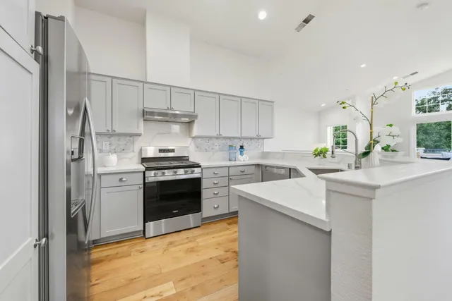 a kitchen with a stove cabinets and a refrigerator