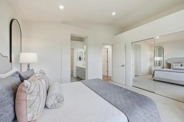 a bedroom with a bed and a lamp