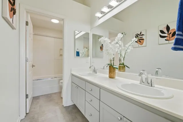 a bathroom with a double vanity sink and a mirror