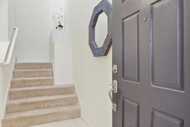 a view of staircase with white walls and a window