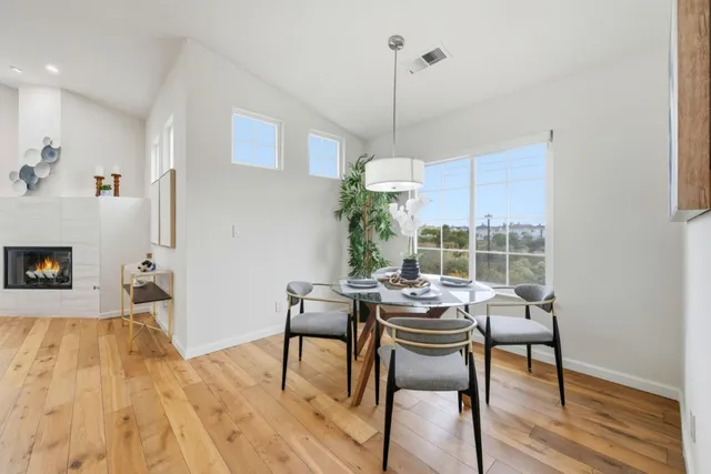 a view of a dining room with furniture window and wooden floor