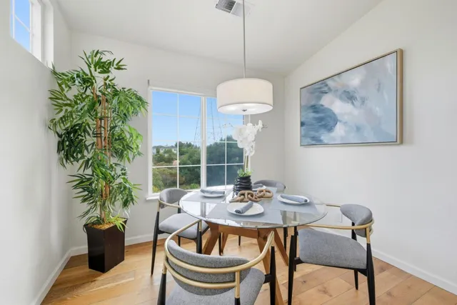 a view of a dining room with furniture window and wooden floor