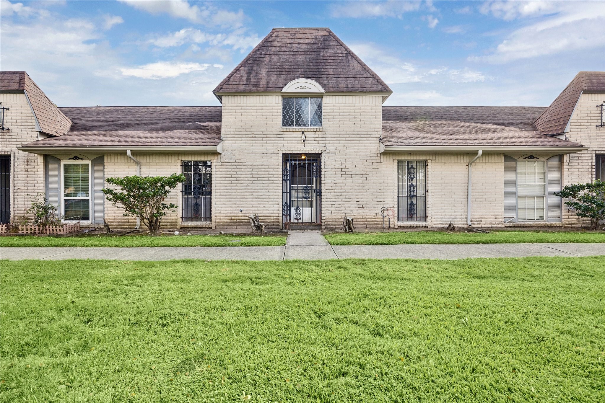 a front view of a house with garden