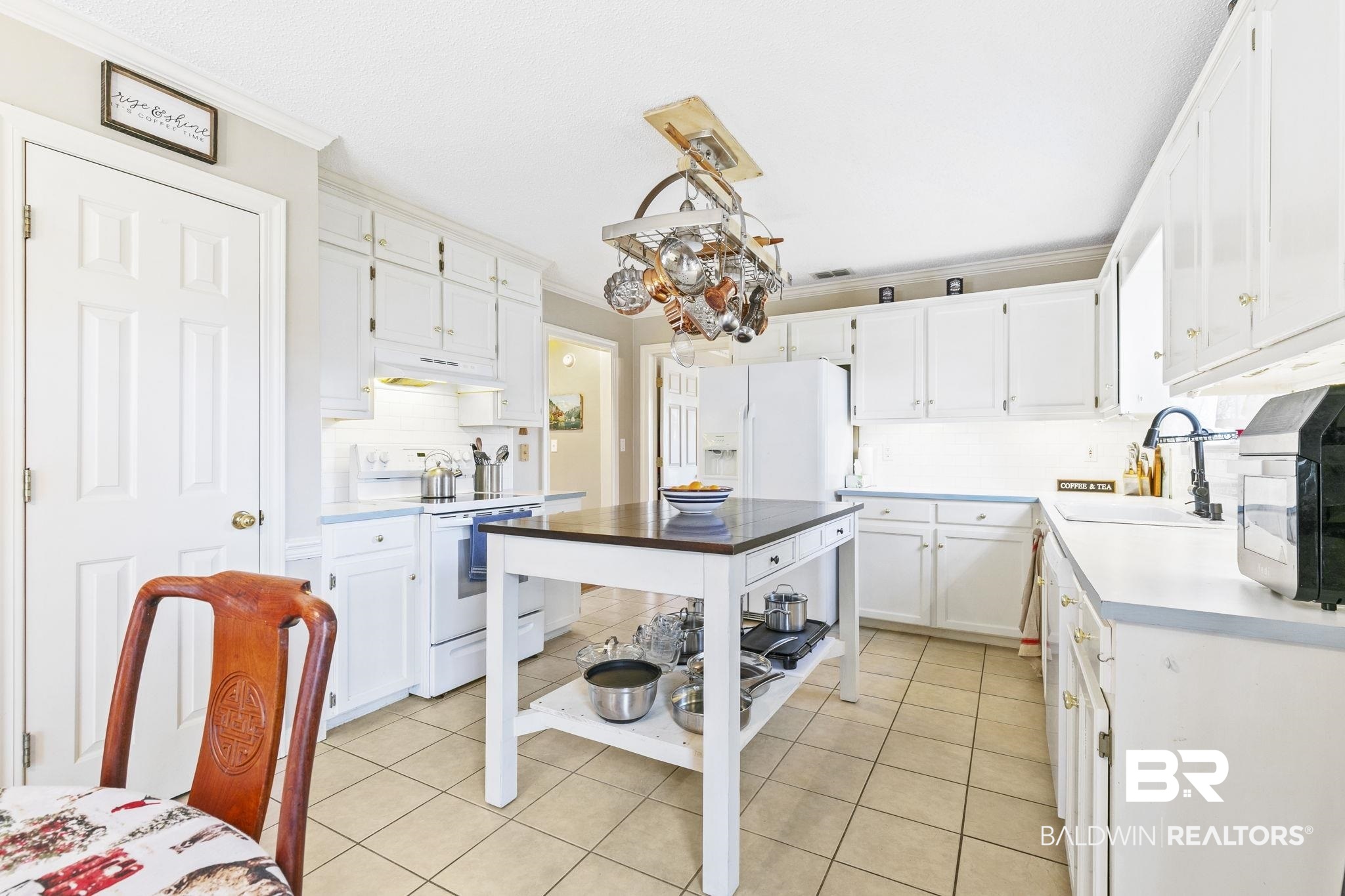 22 Pirates Lane Daphne, AL 36527 - Photo 14 of 36 Kitchen featuring white appliances, decorative light fixtures, white cabinetry, and crown molding