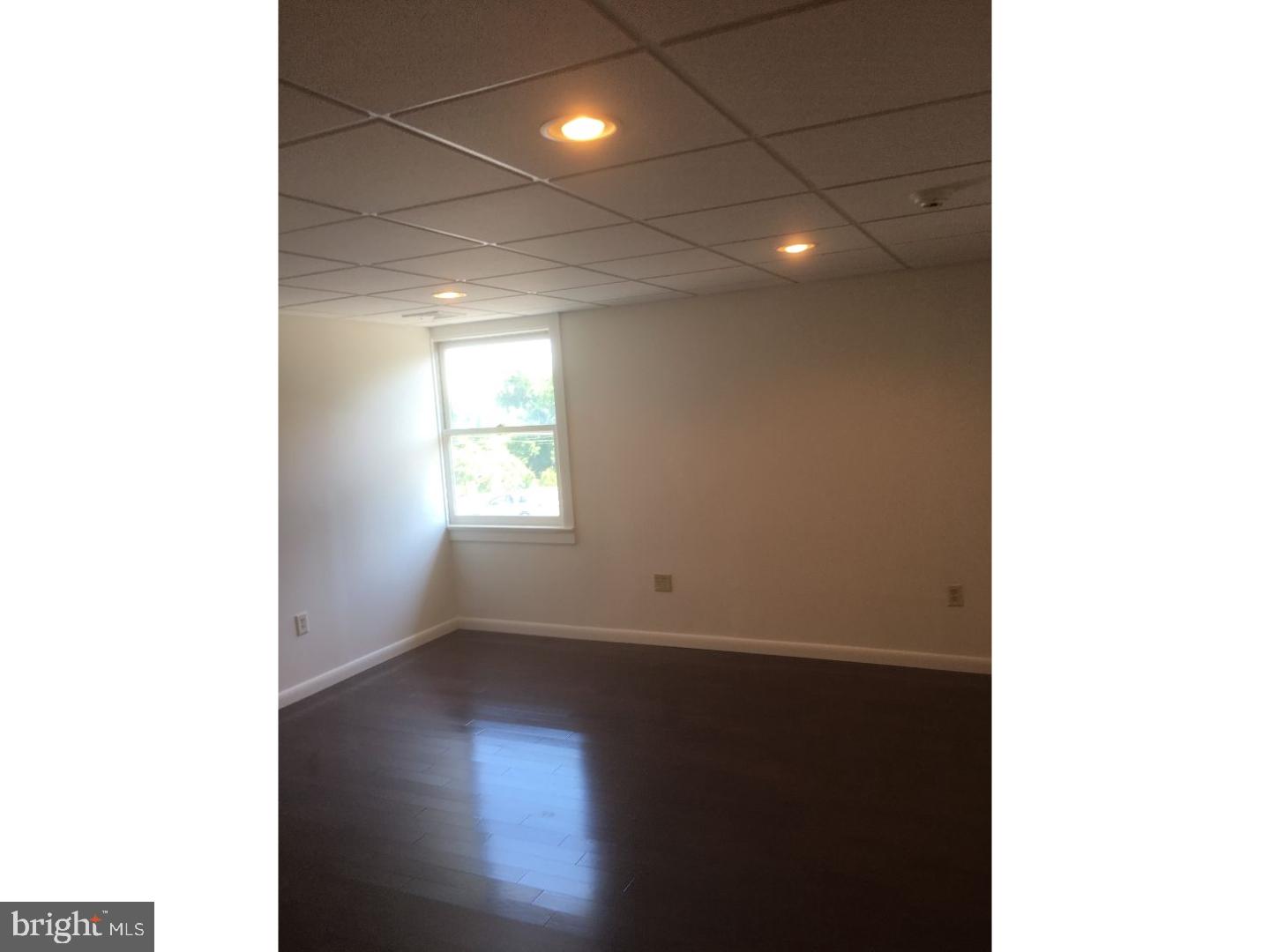 4 Beryl Road Paoli, PA 19301 - Photo 7 of 12 a view of an empty room with wooden floor and a window