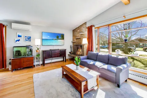 a living room with furniture and a dining table
