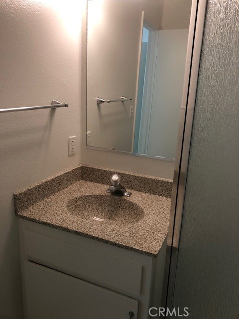 207 West Marquita, Unit 6 San Clemente, CA 92672 - Photo 14 of 15 a bathroom with a granite countertop sink and a mirror
