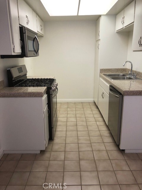 207 West Marquita, Unit 6 San Clemente, CA 92672 - Photo 7 of 15 a kitchen with a sink and a stove top oven