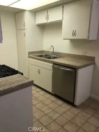 a kitchen with stainless steel appliances granite countertop a sink and a stove