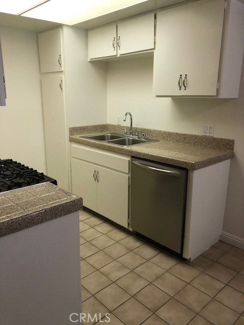 207 West Marquita, Unit 6 San Clemente, CA 92672 - Photo 9 of 15 a kitchen with stainless steel appliances granite countertop a sink and a stove