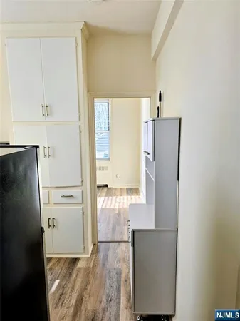 a kitchen with a refrigerator and cabinets