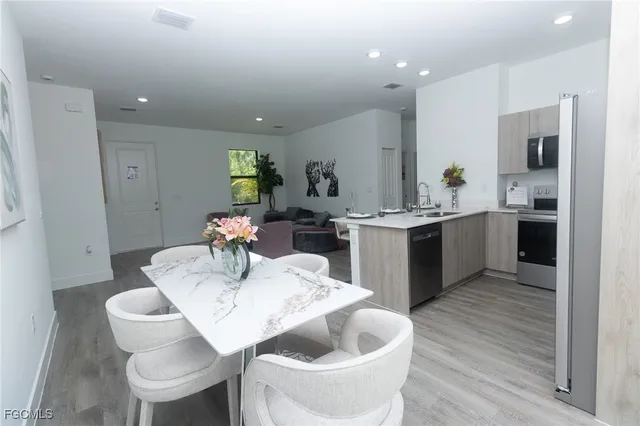 a kitchen with a sink and chairs