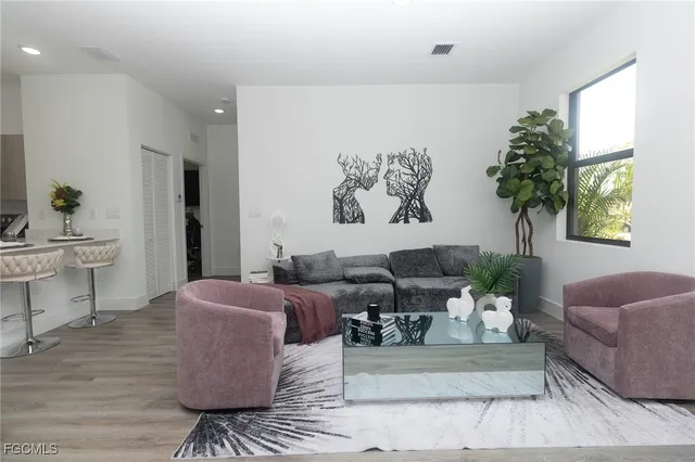 a living room with furniture and a potted plant