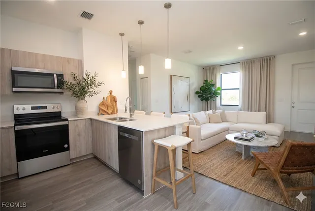 a kitchen with a table chairs stove and microwave