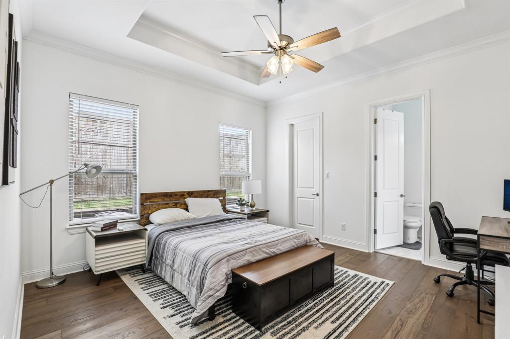 515 West Laureland Road Dallas, TX 75232 - Photo 18 of 32 a bedroom with a bed and a chandelier