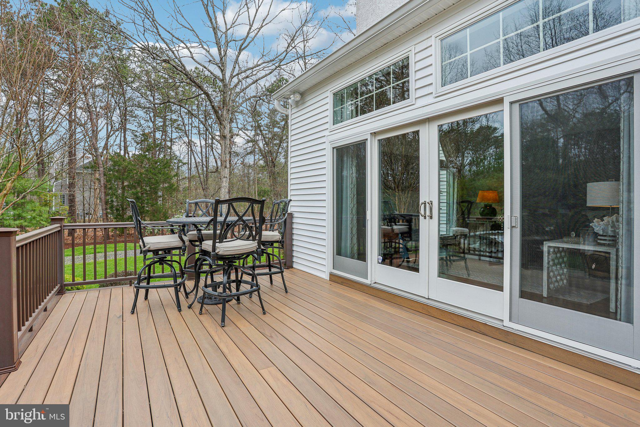 6 Stowe Drive Shamong, NJ 08088 - Photo 56 of 76 a view of a roof deck with table and chairs floor to ceiling window with wooden floor