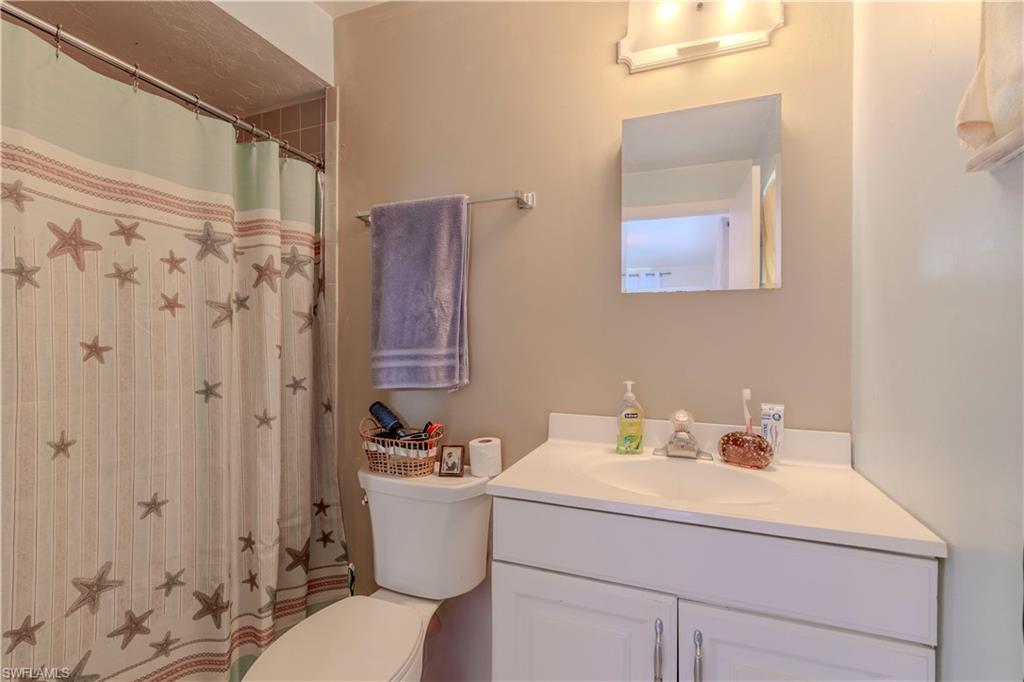 4484 30th Place Southwest Naples, FL 34116 - Photo 12 of 20 Bathroom featuring a shower with curtain and vanity