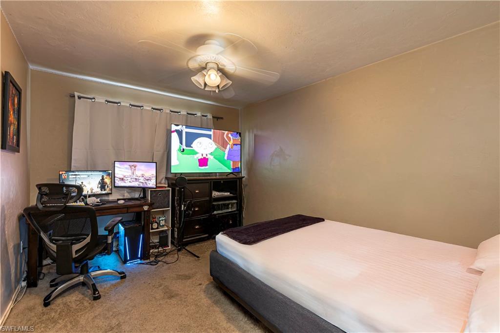 4484 30th Place Southwest Naples, FL 34116 - Photo 8 of 20 Carpeted bedroom featuring ceiling fan and a desk