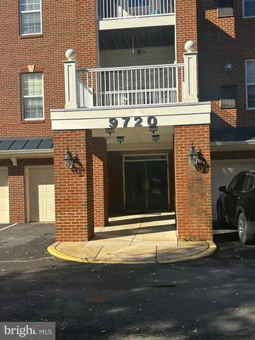 a kitchen with stainless steel appliances granite countertop a refrigerator a stove top oven a sink dishwasher a dining table and chairs with wooden floor