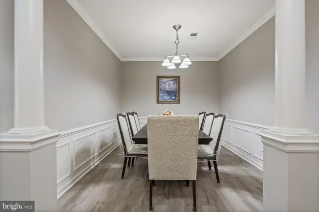 a view of a dining room with furniture wooden floor and chandelier