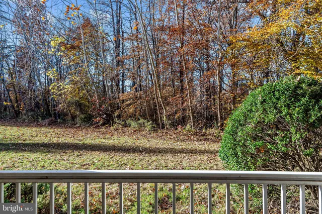 a view of a yard with wooden fence