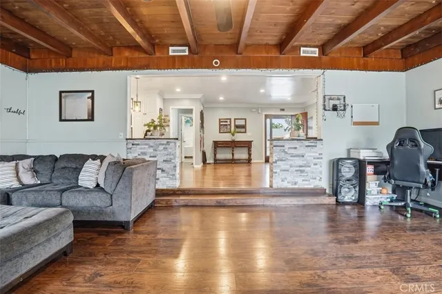a living room with furniture and wooden floors