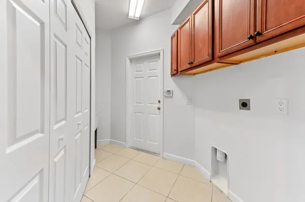 a view of empty room with window and wooden floor