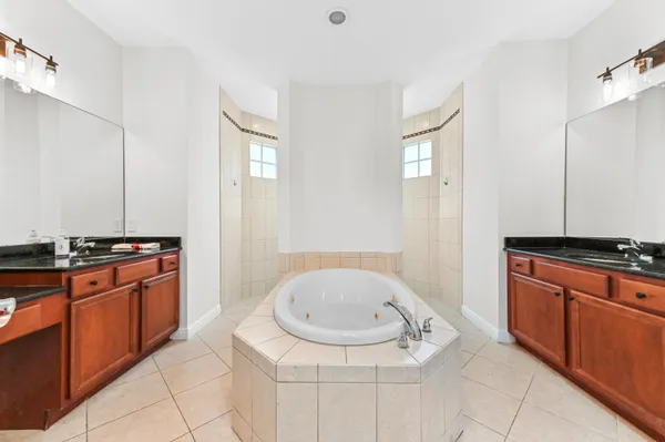 a bathroom with a granite countertop sink toilet a mirror and a shower