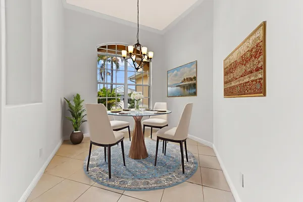 a view of an empty room with window and chandelier