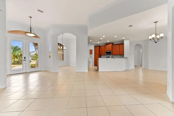 a kitchen with stainless steel appliances granite countertop a stove a sink and a refrigerator with wooden cabinets