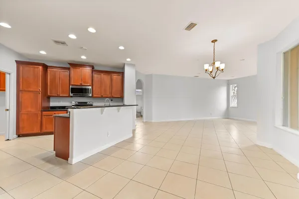 a large kitchen with stainless steel appliances granite countertop a stove and a sink