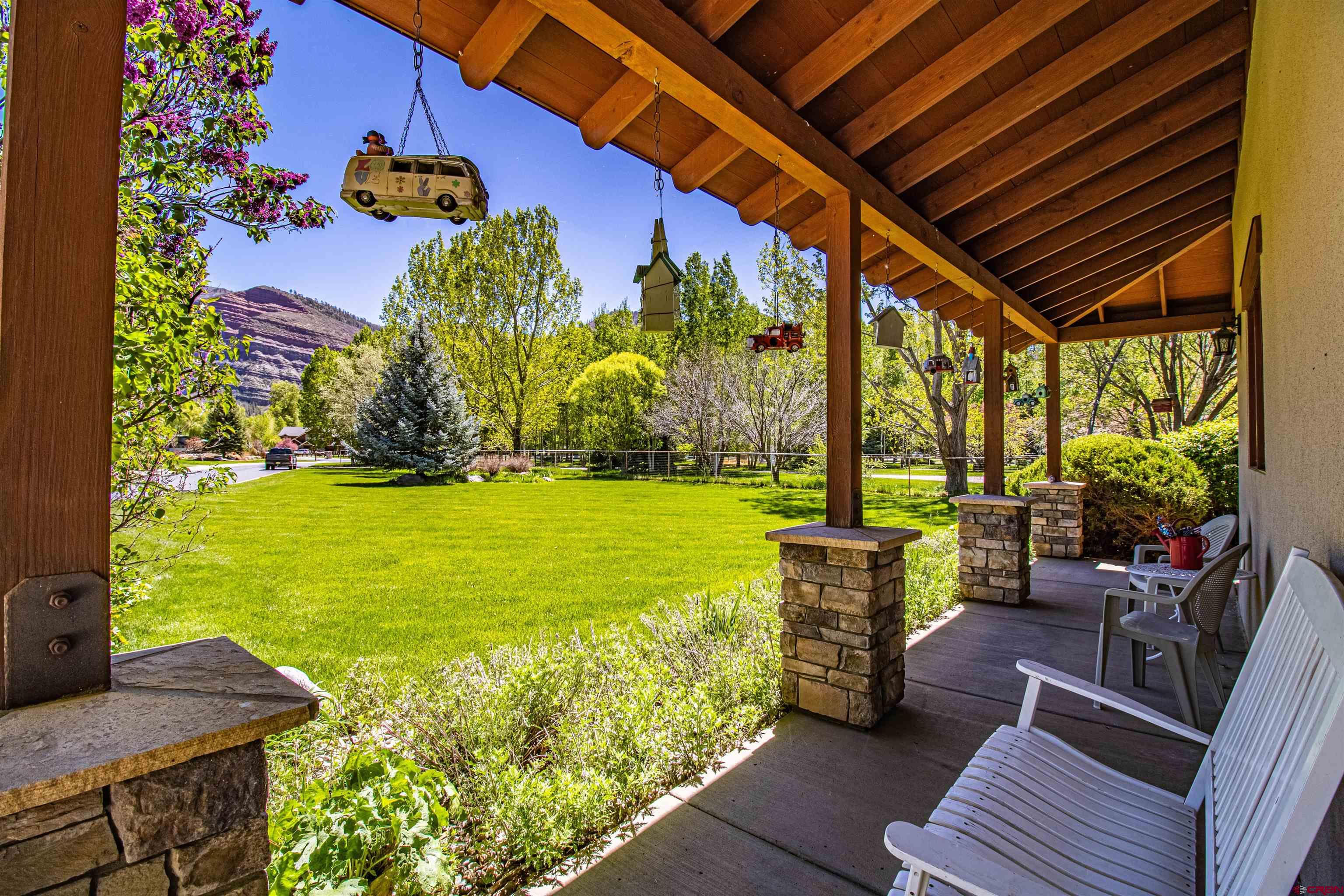 1167 North Dalton Ranch Road Durango, CO 81301 - Photo 36 of 45 a view of a chairs and table in the patio with a garden