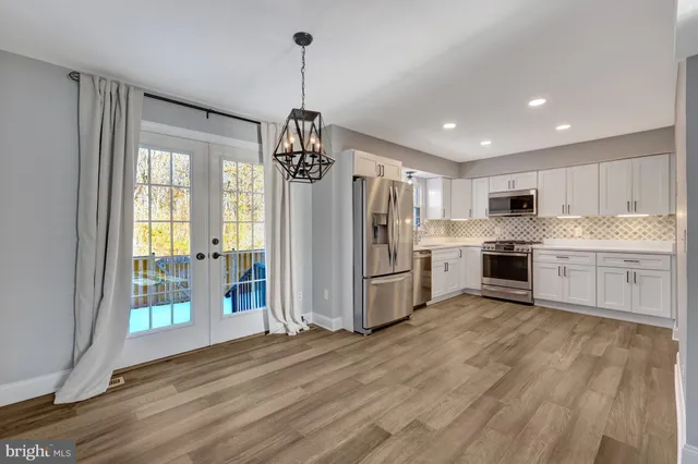 a kitchen with stainless steel appliances a refrigerator sink and cabinets