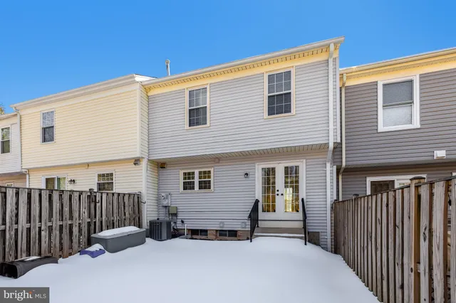 a view of a house with wooden fence