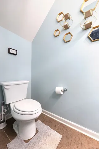 a white toilet sitting next to a bathroom sink