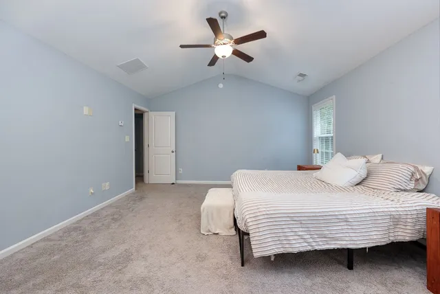 a bedroom with a bed and a ceiling fan