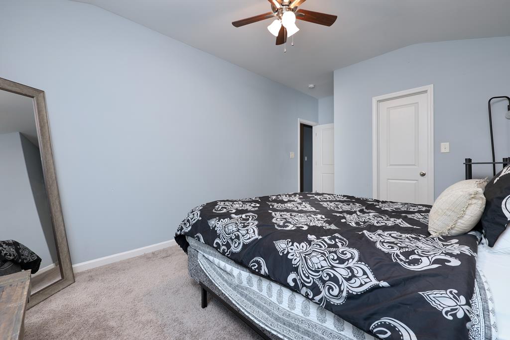 98 Valley Bluff Drive Hamilton, GA 31811 - Photo 29 of 35 a bedroom with a bed and a chandelier