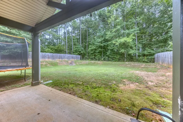 a view of a porch with a table and chairs