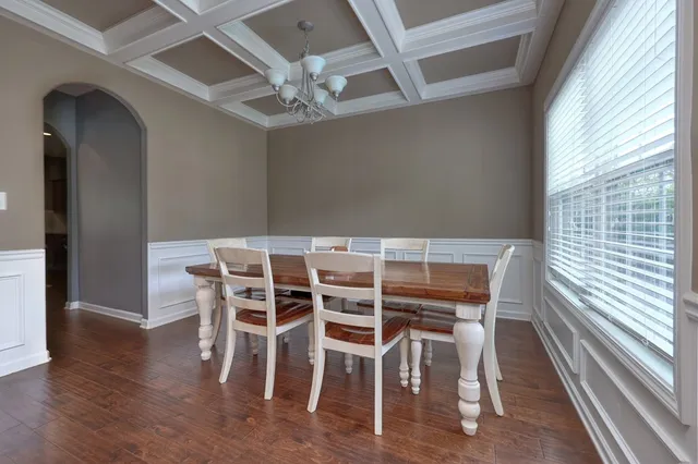 a view of a dining room with furniture wooden floor and chandelier