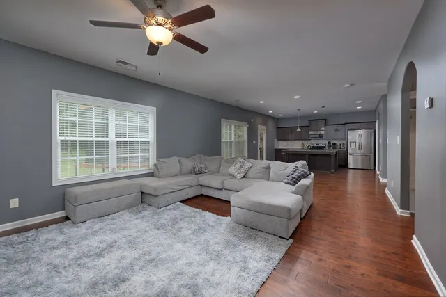 a living room with furniture and a chandelier