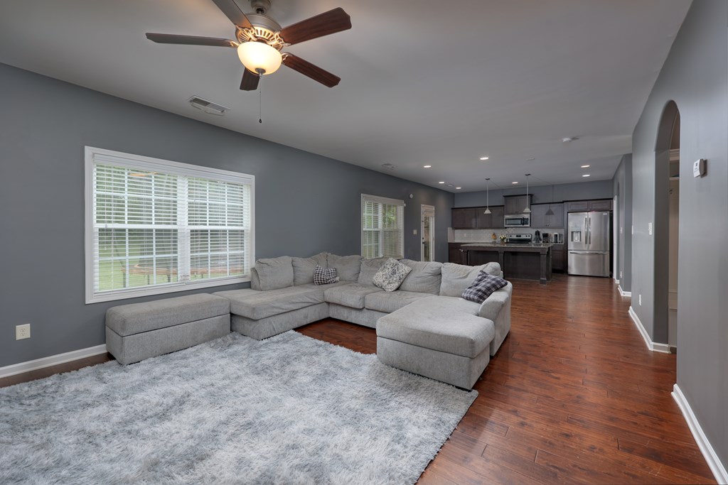 98 Valley Bluff Drive Hamilton, GA 31811 - Photo 10 of 35 a living room with furniture and a chandelier