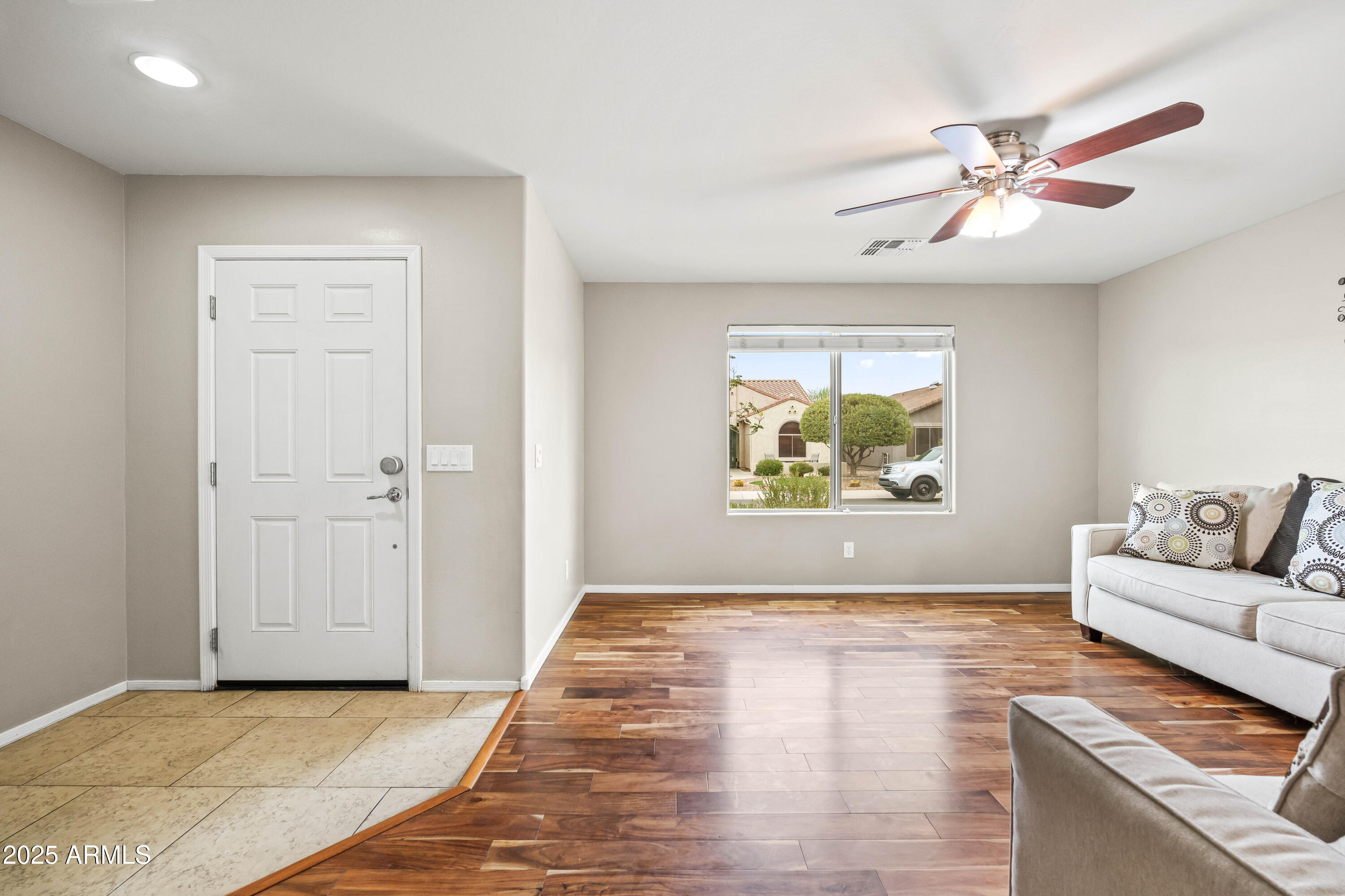 6525 West Georgetown Way Florence, AZ 85132 - Photo 13 of 82 a view of an empty room with window a ceiling fan and wooden floor
