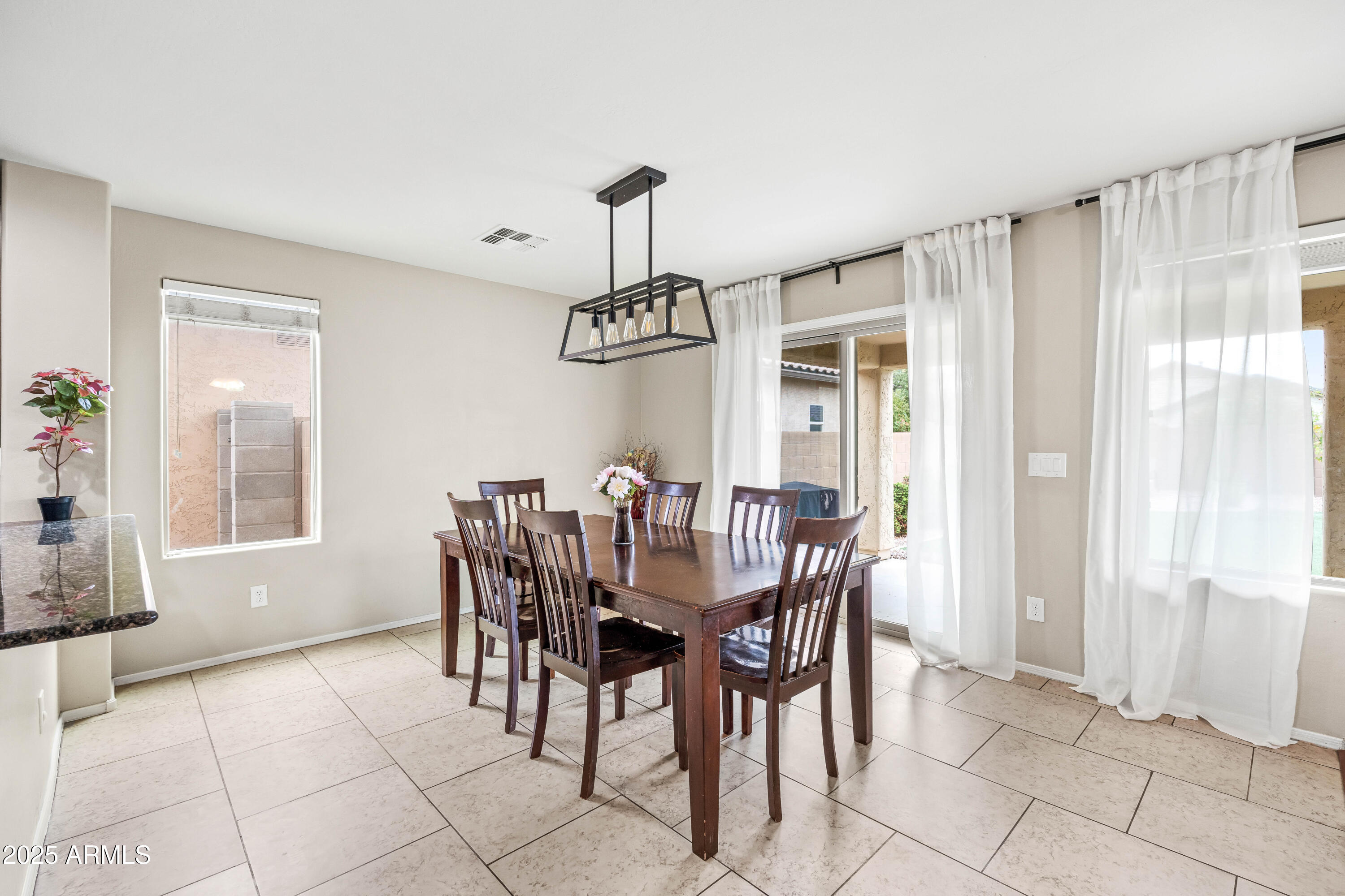6525 West Georgetown Way Florence, AZ 85132 - Photo 20 of 82 a dining room with furniture a chandelier and window