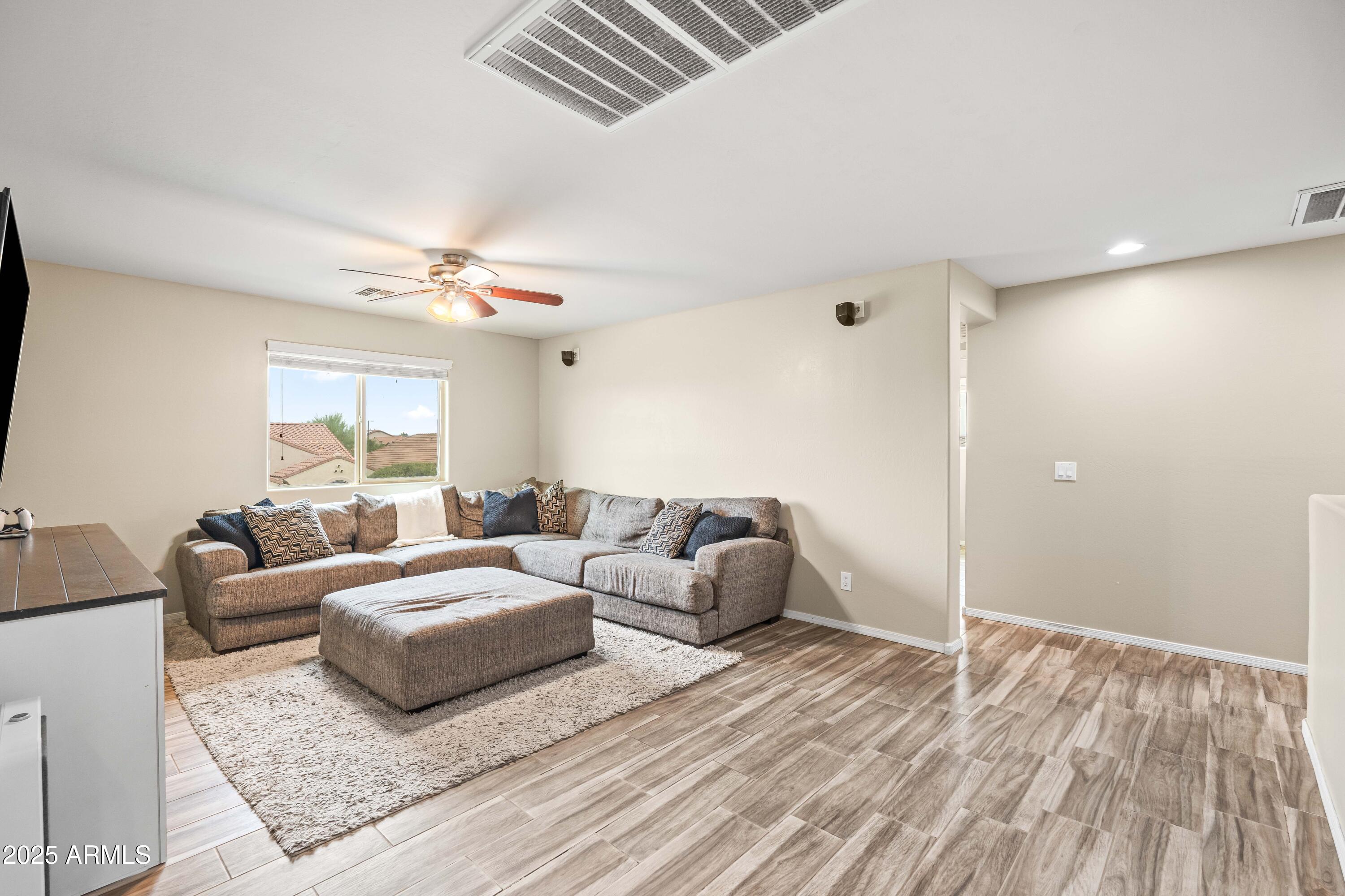 6525 West Georgetown Way Florence, AZ 85132 - Photo 29 of 82 a living room with furniture and a flat screen tv
