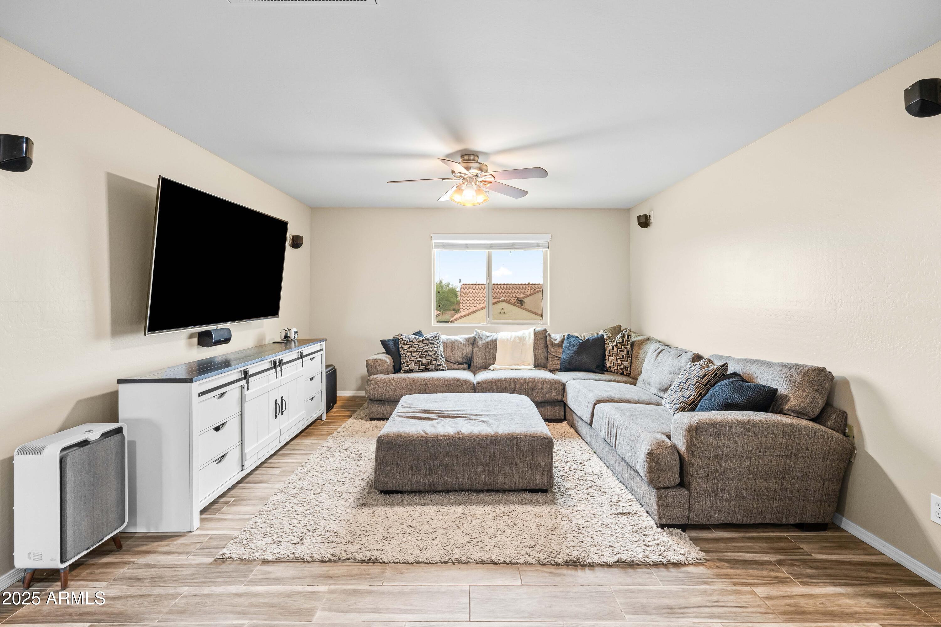 6525 West Georgetown Way Florence, AZ 85132 - Photo 30 of 82 a living room with furniture and a flat screen tv