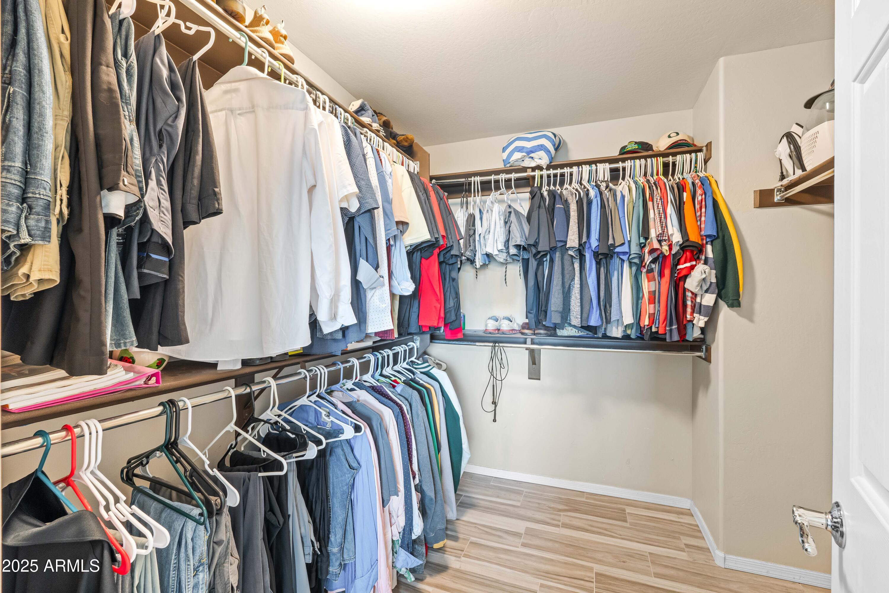 6525 West Georgetown Way Florence, AZ 85132 - Photo 35 of 82 a view of walk in closet with clothes and shoes