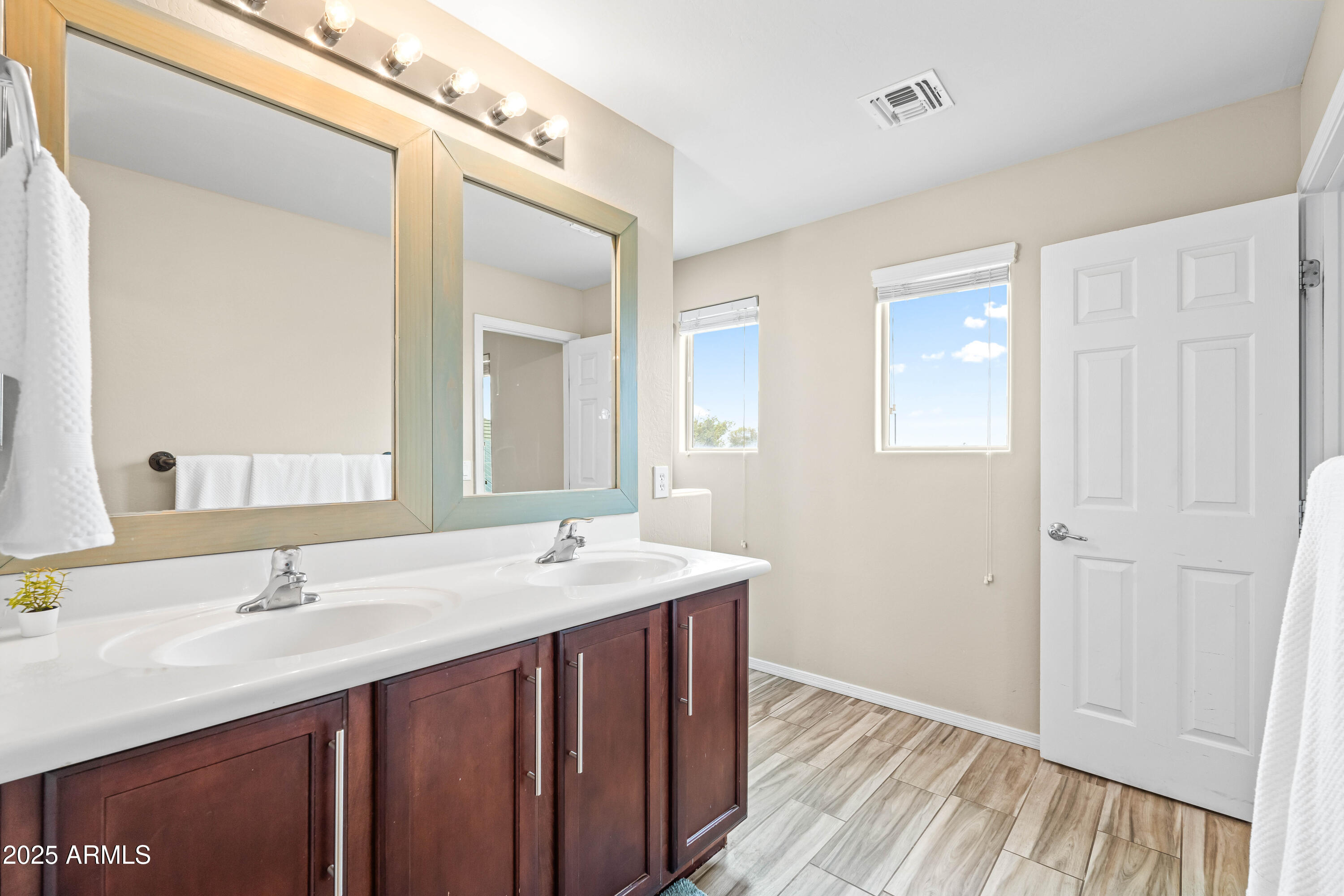 6525 West Georgetown Way Florence, AZ 85132 - Photo 37 of 82 a bathroom with a double vanity sink and a mirror