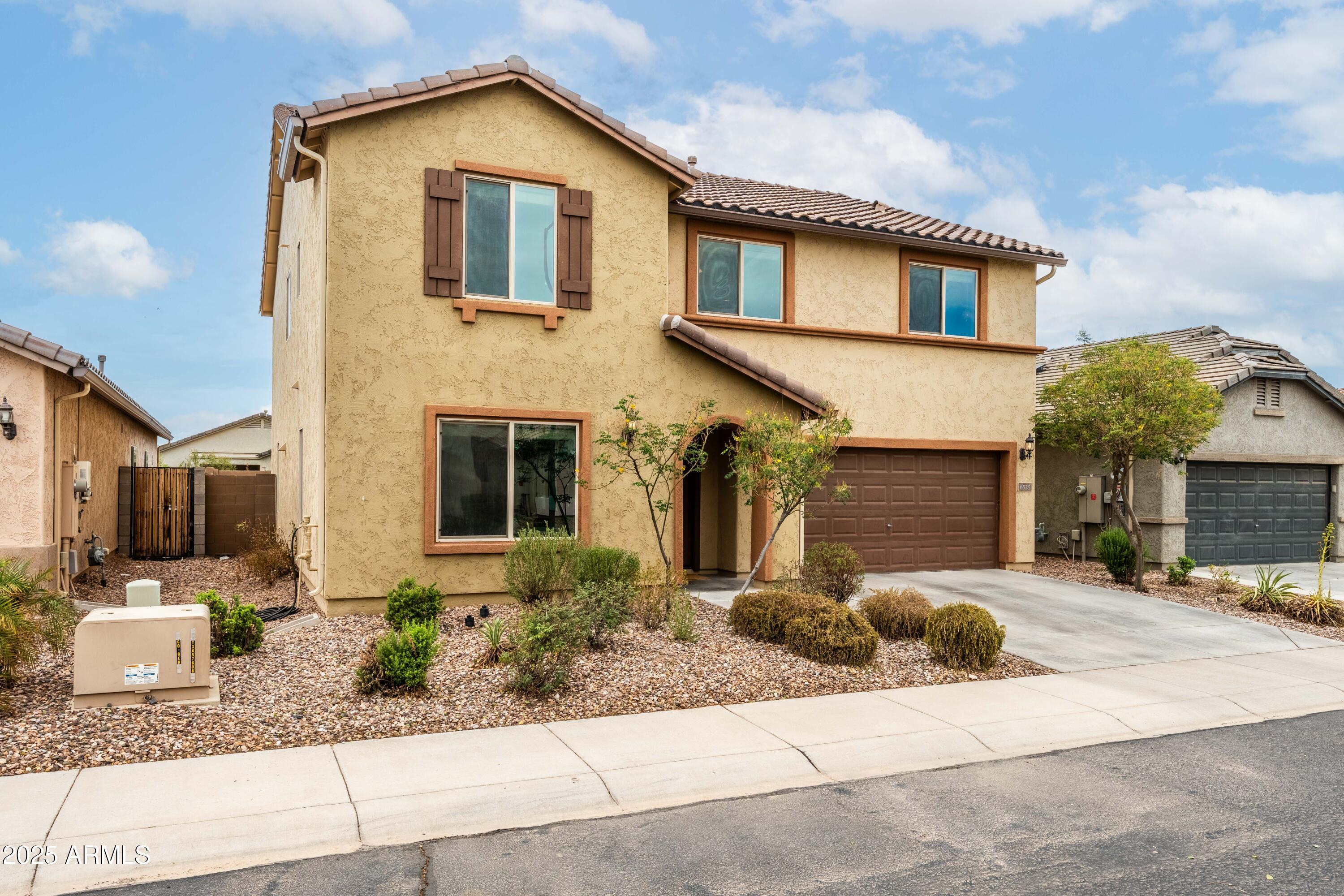 6525 West Georgetown Way Florence, AZ 85132 - Photo 8 of 82 a front view of a house with a yard and potted plants