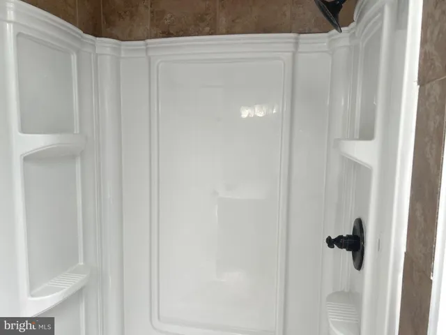 an empty room with wooden floor and closet